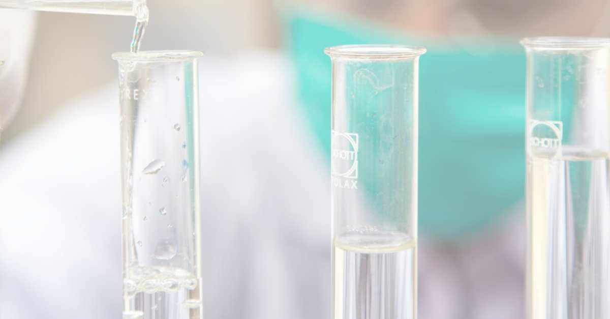 Pouring clear liquid in test tubes as a concept of translating R&amp;D into GMP manufacturing.