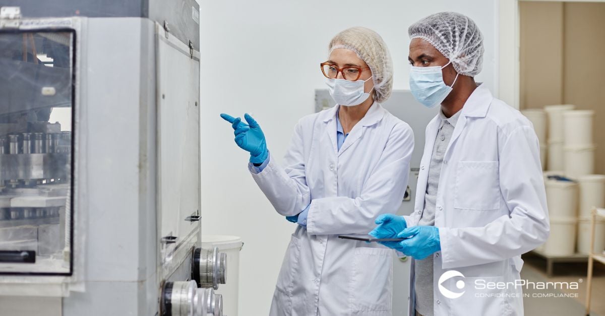 GMP Operator Pointing at Machine and Explaining Production Process