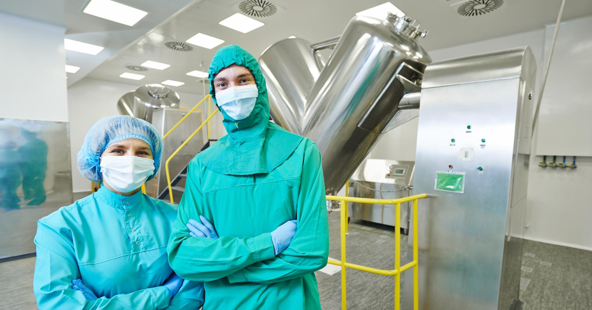 GMP Operators in Pharmaceutical Manufacturing Plant with V-Shaped Blenders