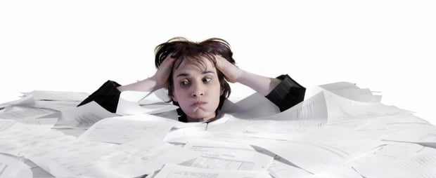 Person stressed by the volume of paper work to do