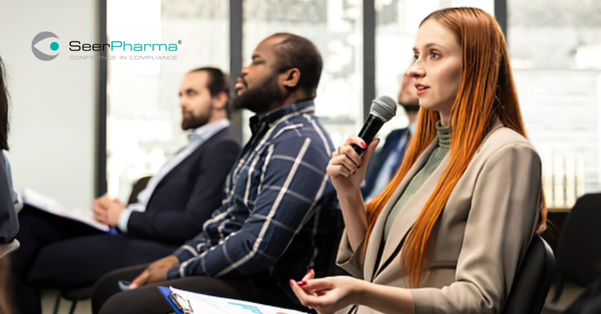 Professional woman asking a question at a live public speaking panel event