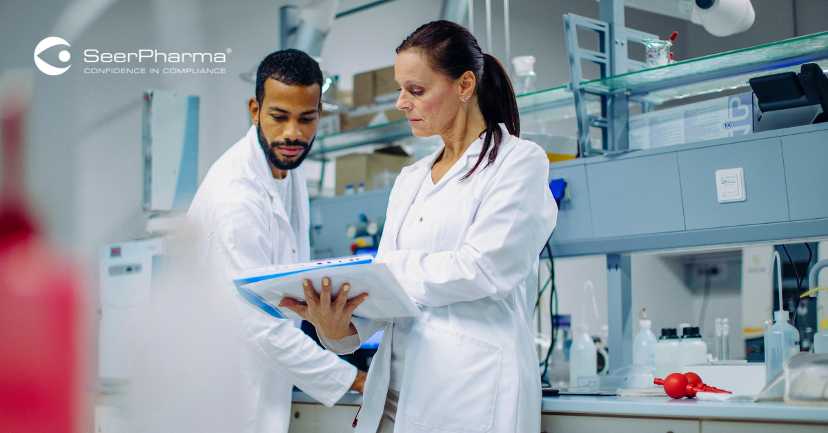 Scientists working in the lab reviewing records