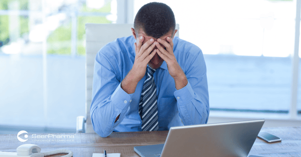 Businessman with head in hands